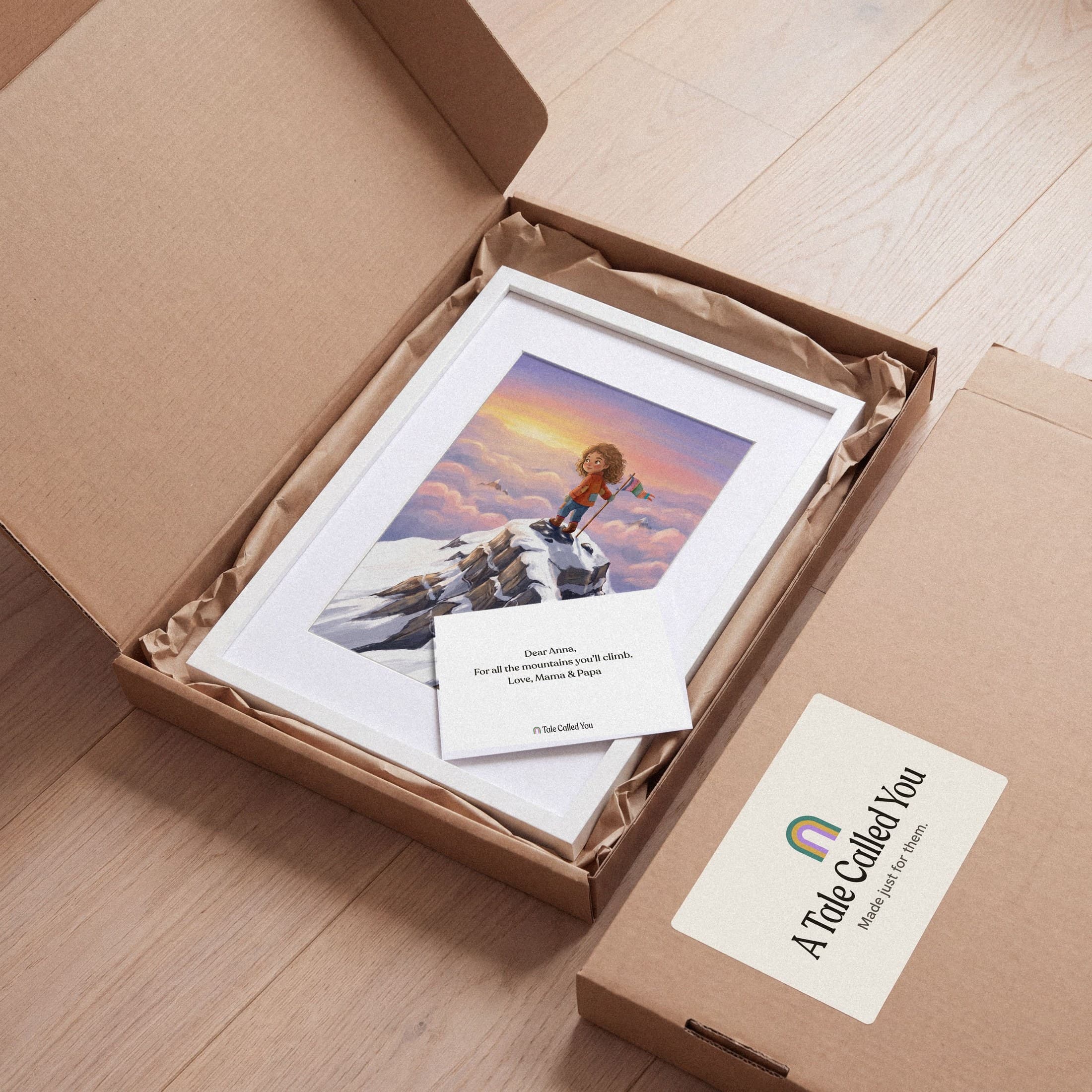 The framed story art lying in its opened shipping box on kraft paper